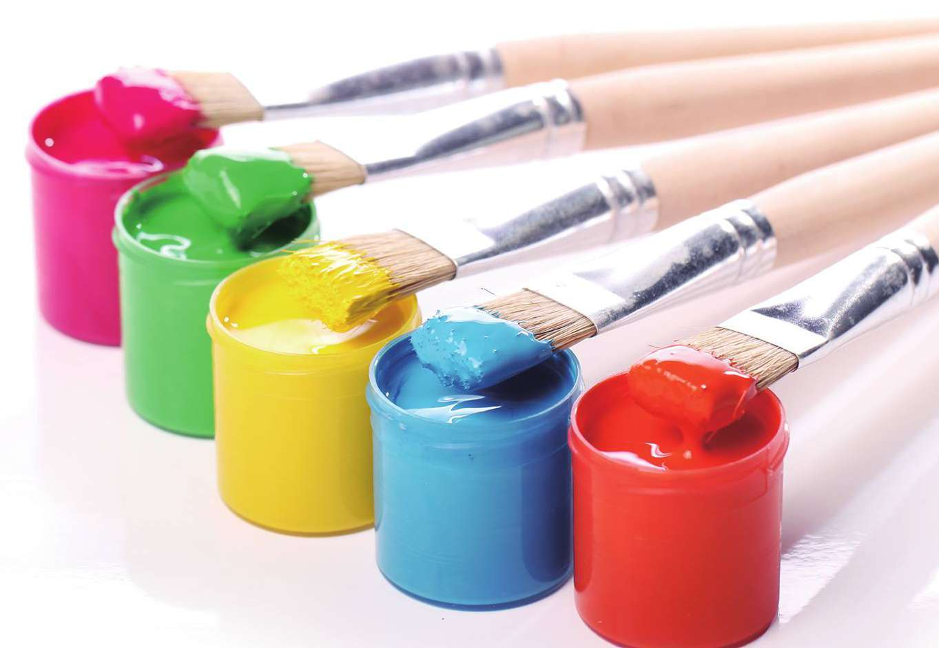 Bright paint pots with brushes